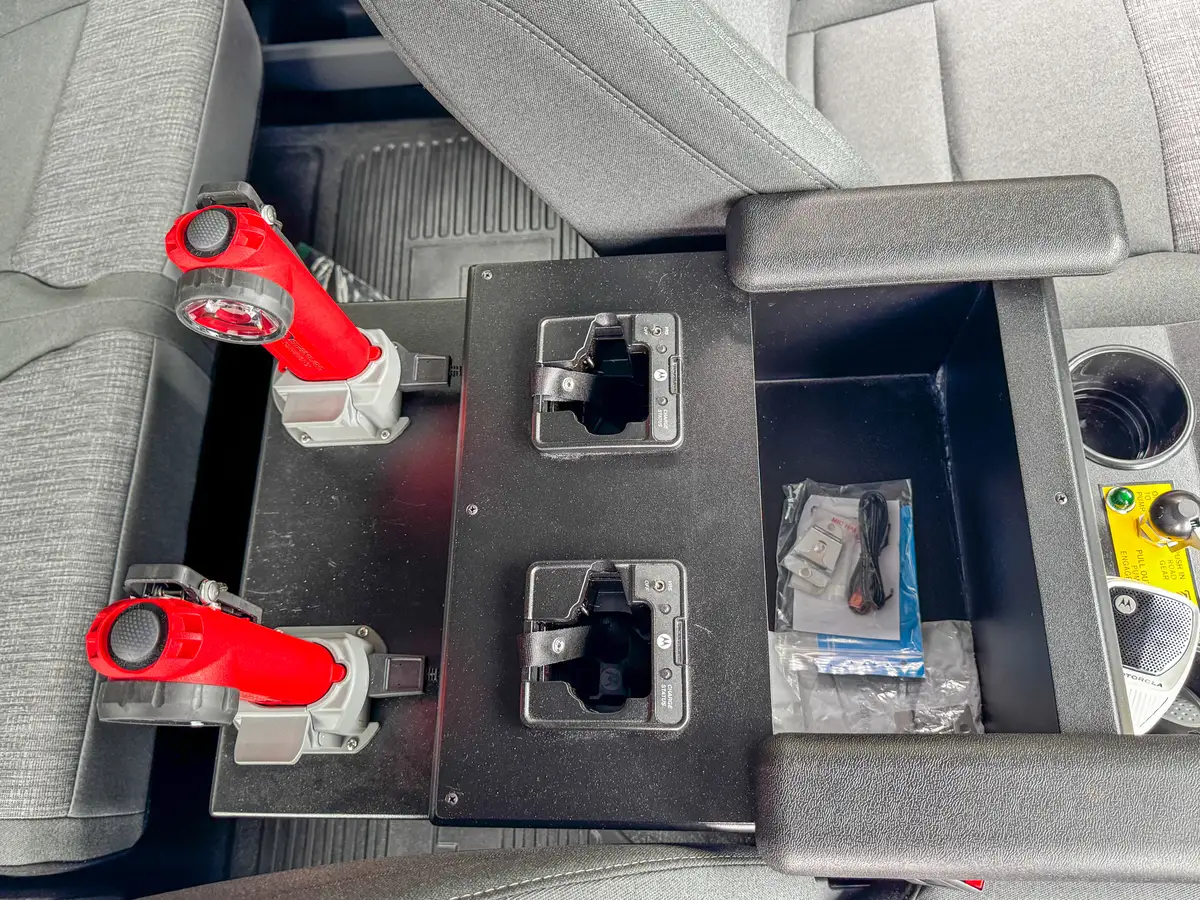 Front-cabin interior wide view with dash screen, steering wheel, and console.